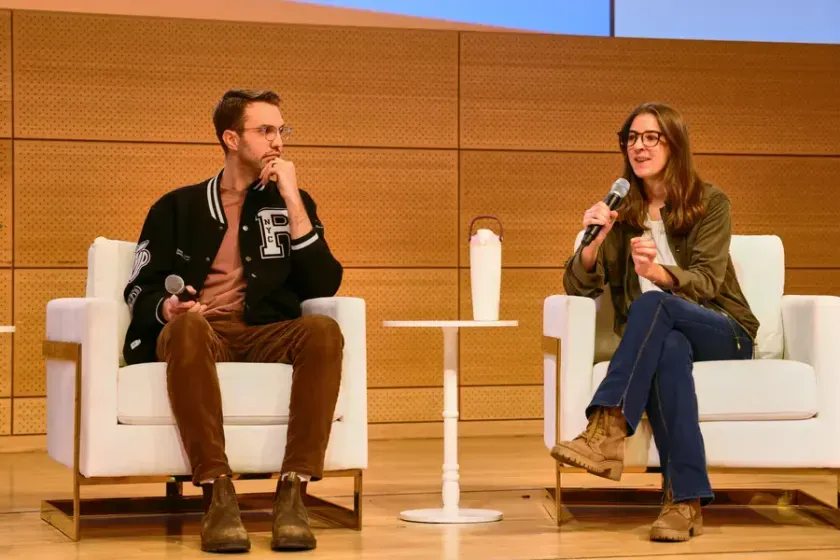 Two speakers in armchairs on the main stage, 2026