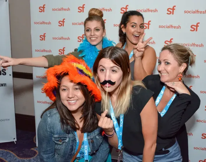 A group playing up to the camera with props, 2016